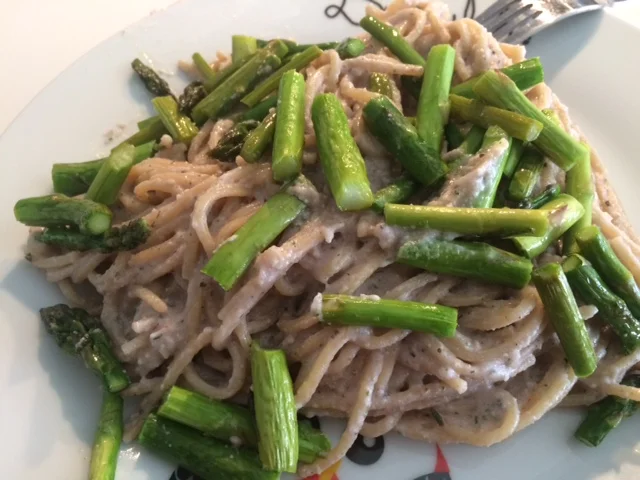 Spaghetti integrales con salsa carbonara vegana y salteado de espárragos verdes